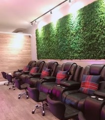 Foot treatment chairs beside a living green wall